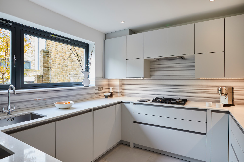 Design ideas for a small contemporary u-shaped enclosed kitchen in London with flat-panel cabinets, grey cabinets, quartz worktops, multi-coloured splashback, marble splashback, stainless steel appliances, ceramic flooring, no island, grey floors, grey worktops and a submerged sink.