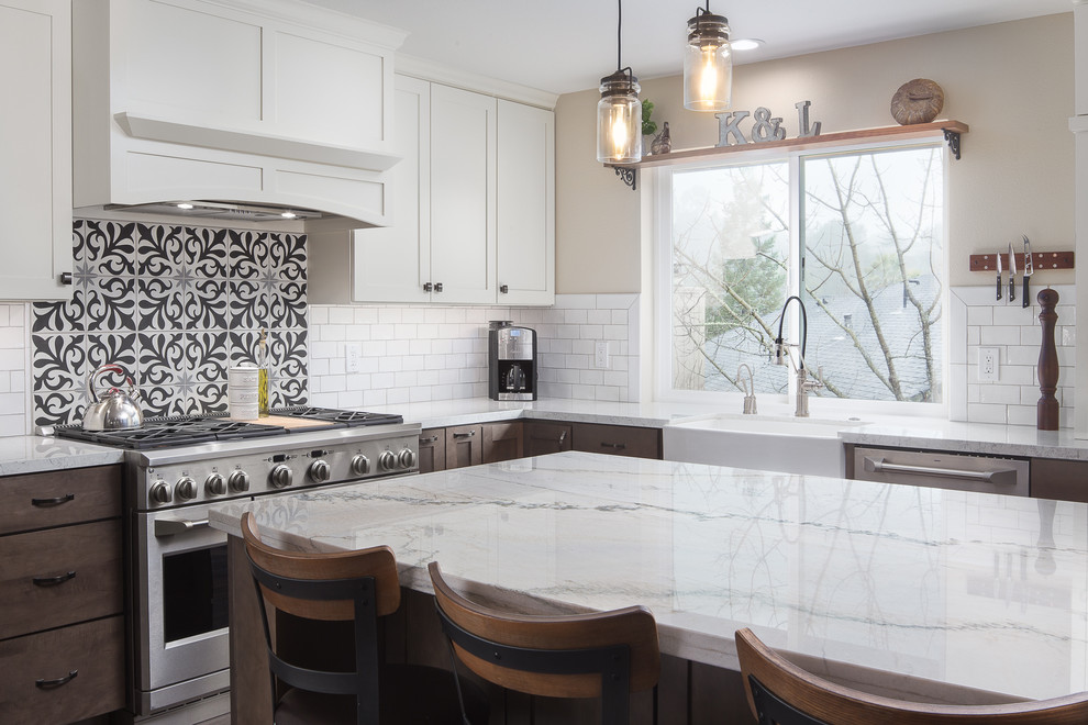Mid-sized transitional l-shaped dark wood floor and brown floor enclosed kitchen photo in Sacramento with a farmhouse sink, shaker cabinets, white cabinets, quartzite countertops, white backsplash, subway tile backsplash, stainless steel appliances and an island