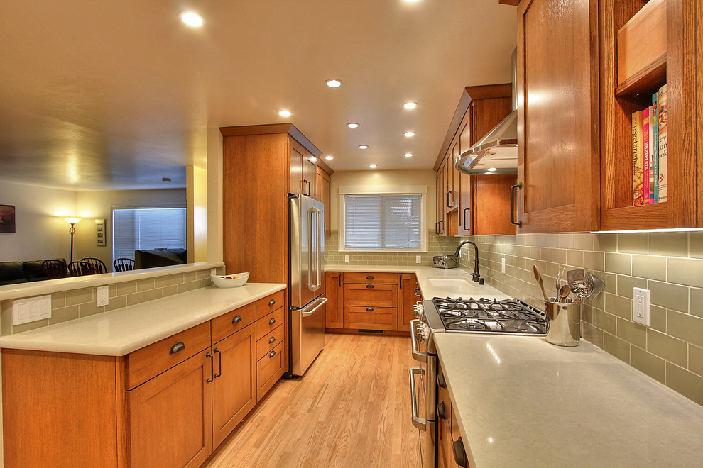 Example of a small minimalist galley light wood floor eat-in kitchen design in San Francisco with an undermount sink, shaker cabinets, medium tone wood cabinets, quartzite countertops, green backsplash, ceramic backsplash, stainless steel appliances and no island