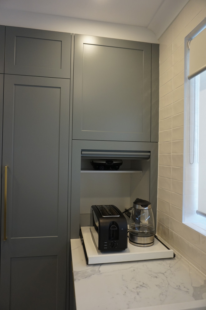 Inspiration for a medium sized contemporary u-shaped enclosed kitchen in Sydney with a double-bowl sink, shaker cabinets, grey cabinets, engineered stone countertops, white splashback, metro tiled splashback, black appliances, porcelain flooring, multi-coloured floors and multicoloured worktops.