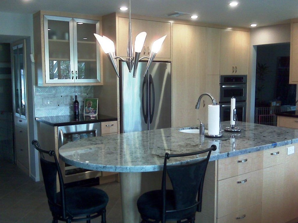 Example of a mid-sized l-shaped kitchen design in Orange County with flat-panel cabinets