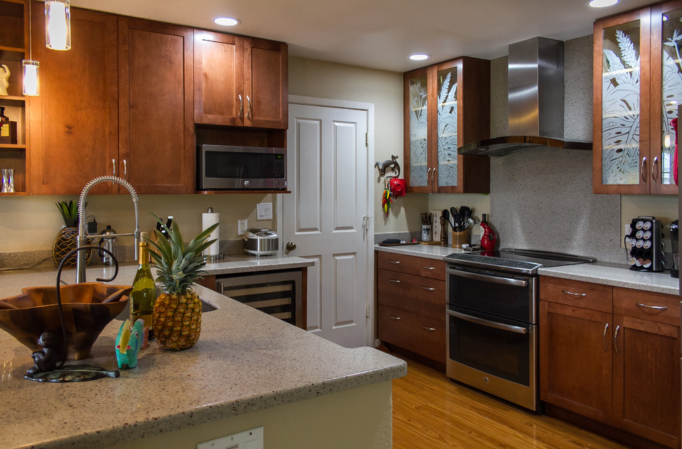 Kitchen - mid-sized tropical medium tone wood floor kitchen idea in Hawaii with an undermount sink, shaker cabinets, red cabinets, solid surface countertops, multicolored backsplash, stainless steel appliances and a peninsula