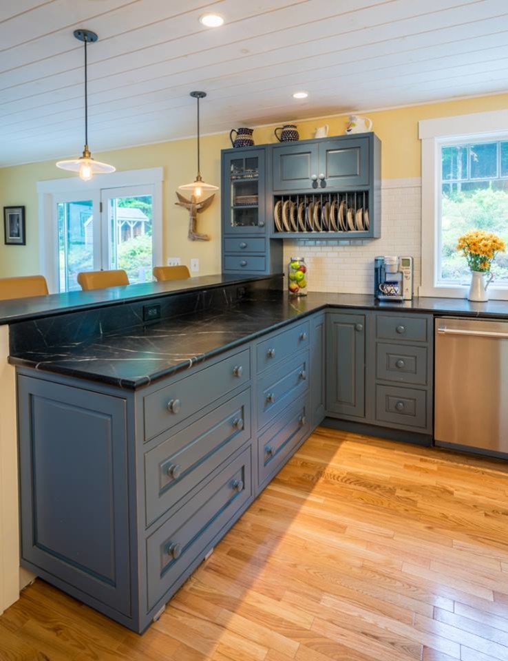 Inspiration for a large u-shaped kitchen in New York with a belfast sink, blue cabinets, soapstone worktops, white splashback, stainless steel appliances, light hardwood flooring and an island.