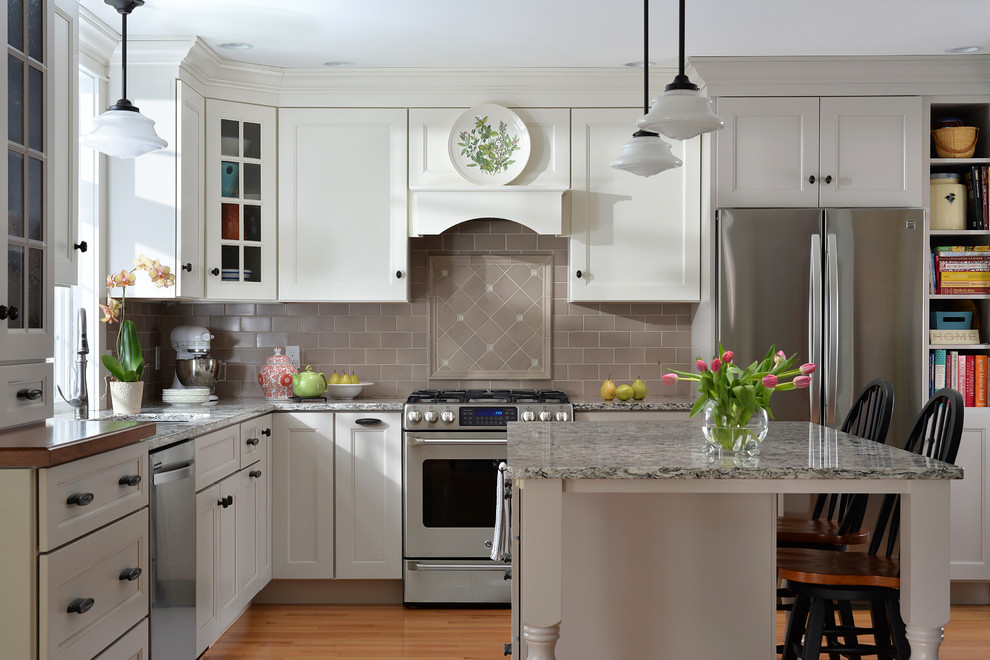 Inspiration for a classic kitchen in Portland Maine with light hardwood flooring and an island.