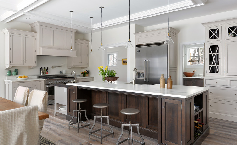 Inspiration for a transitional kitchen remodel in Portland Maine with stainless steel appliances and an island