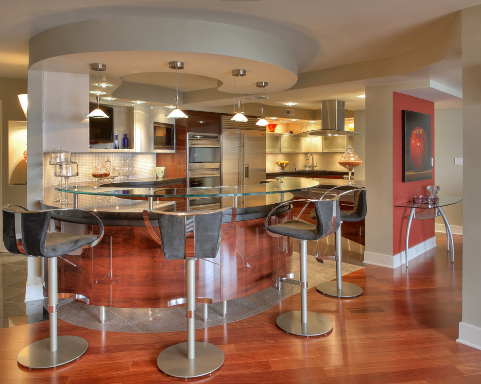 Example of a trendy eat-in kitchen design in DC Metro with an undermount sink, glass-front cabinets, dark wood cabinets, glass countertops, gray backsplash, glass tile backsplash and stainless steel appliances