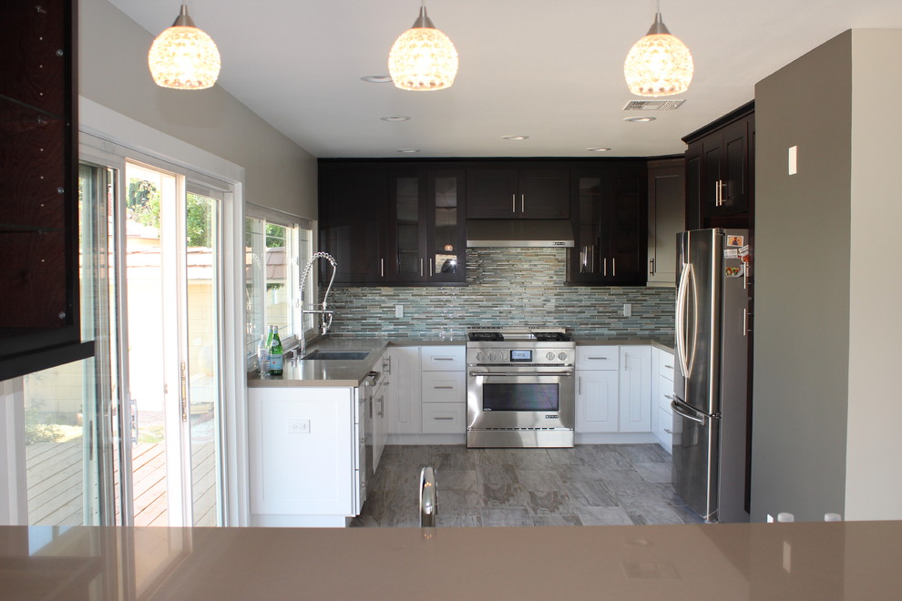 Example of a mid-sized minimalist u-shaped porcelain tile eat-in kitchen design in Los Angeles with an undermount sink, shaker cabinets, dark wood cabinets, quartz countertops, green backsplash, mosaic tile backsplash, stainless steel appliances and no island