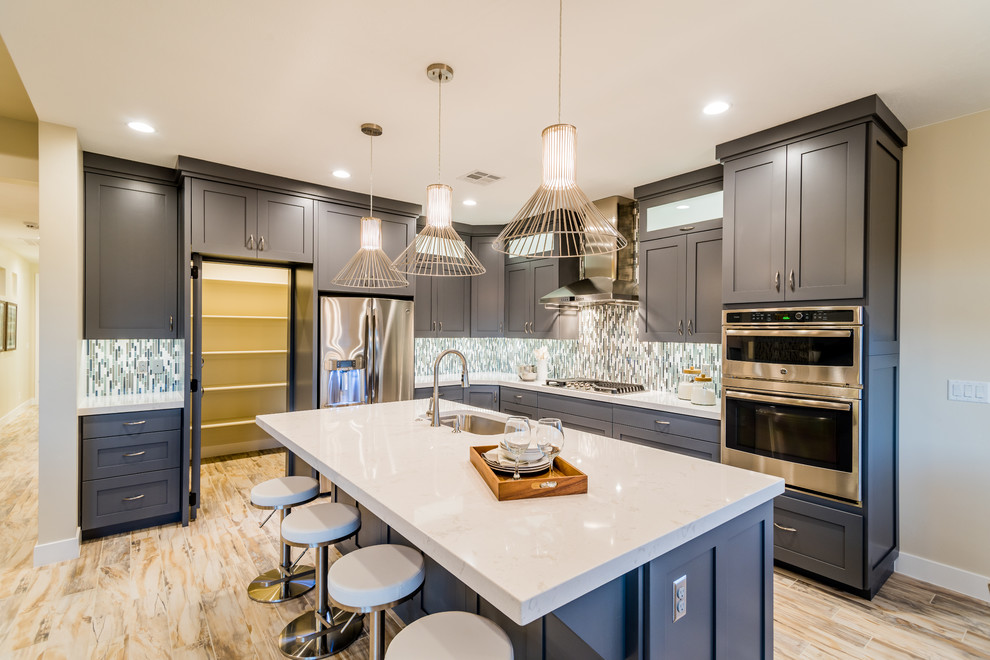 Eat-in kitchen - mid-sized contemporary l-shaped light wood floor eat-in kitchen idea in Salt Lake City with shaker cabinets, gray cabinets, marble countertops, multicolored backsplash, mosaic tile backsplash, stainless steel appliances, an island and an undermount sink