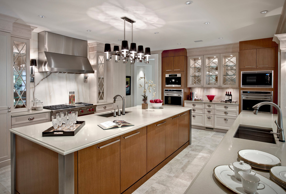 Transitional eat-in kitchen photo in Detroit with an undermount sink, recessed-panel cabinets, white backsplash, stainless steel appliances, stone slab backsplash and medium tone wood cabinets