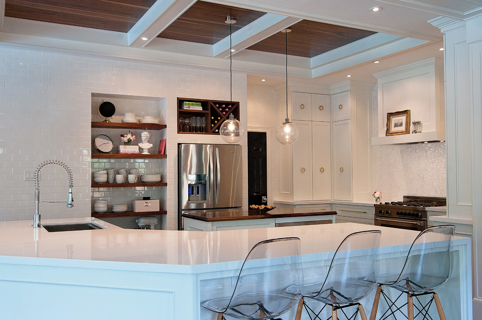 Design ideas for a large traditional open plan kitchen in Houston with a single-bowl sink, shaker cabinets, white cabinets, engineered stone countertops, white splashback, mosaic tiled splashback, stainless steel appliances, dark hardwood flooring and multiple islands.