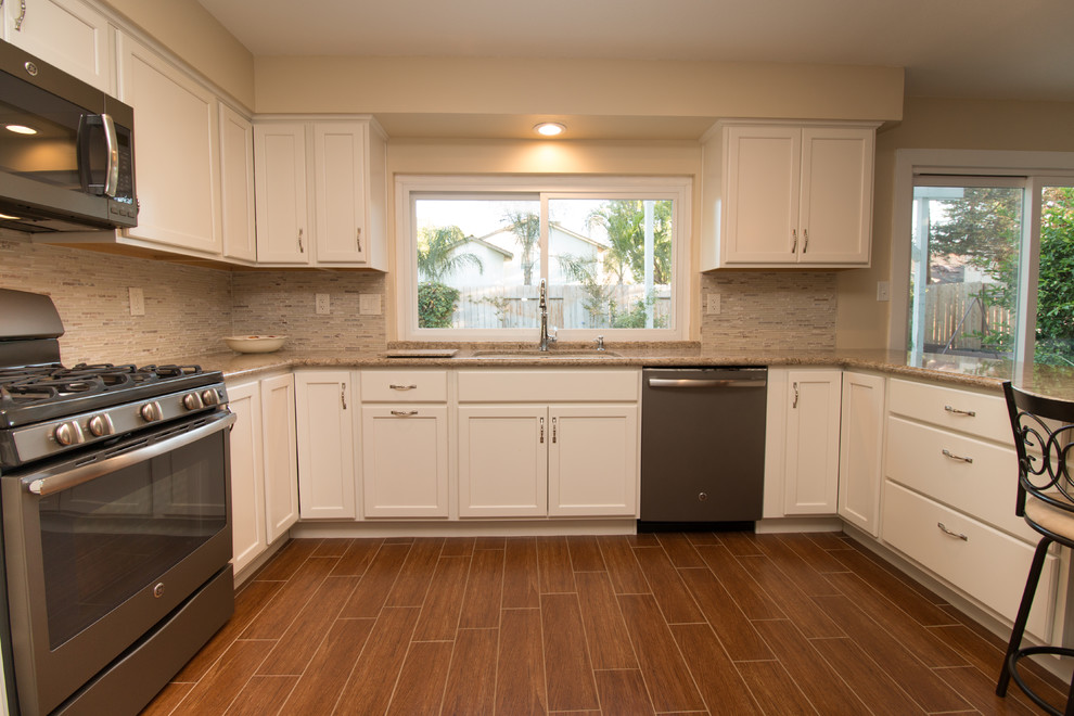 Example of a mid-sized transitional u-shaped porcelain tile open concept kitchen design in Other with an undermount sink, recessed-panel cabinets, beige cabinets, quartz countertops, beige backsplash, mosaic tile backsplash and colored appliances