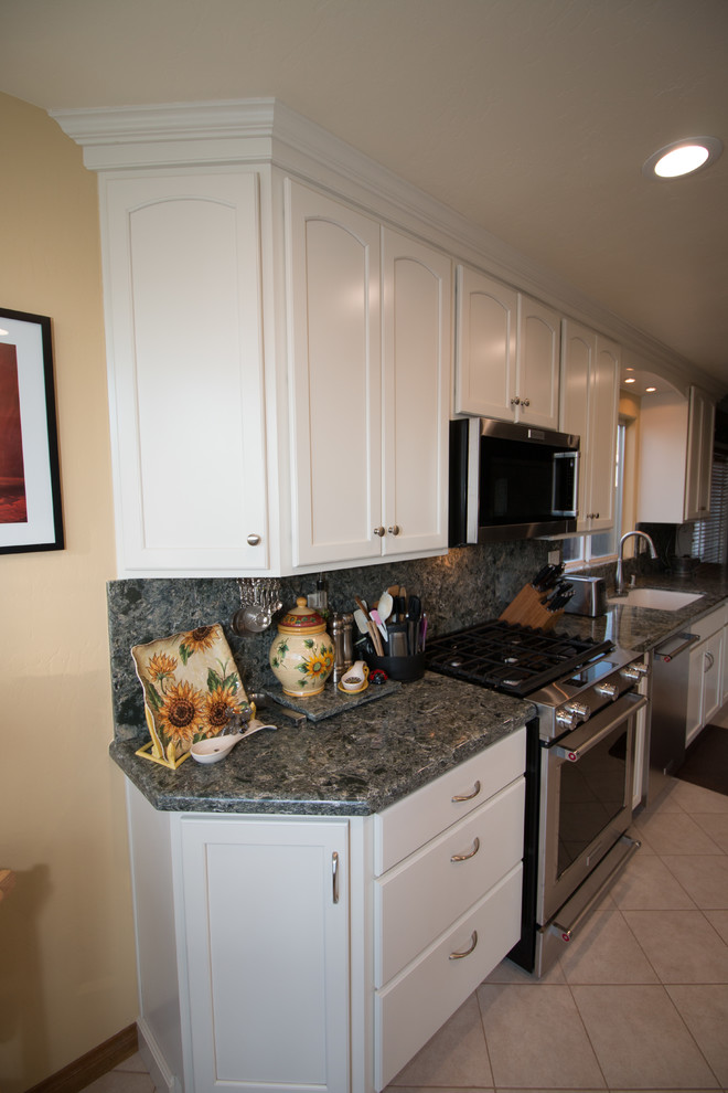 Example of a mid-sized classic galley porcelain tile and beige floor kitchen design in Other with an undermount sink, recessed-panel cabinets, white cabinets, quartz countertops, green backsplash, stainless steel appliances and green countertops