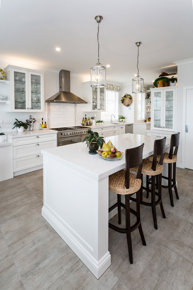 Large elegant galley medium tone wood floor and brown floor eat-in kitchen photo in Auckland with an undermount sink, recessed-panel cabinets, white cabinets, quartz countertops, white backsplash, porcelain backsplash, stainless steel appliances and an island