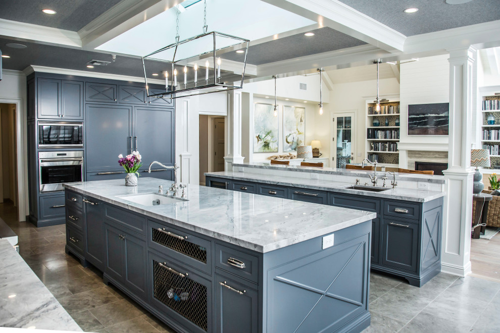Kitchen - large transitional l-shaped porcelain tile and gray floor kitchen idea in Los Angeles with an undermount sink, shaker cabinets, gray cabinets, stainless steel appliances, two islands and gray countertops