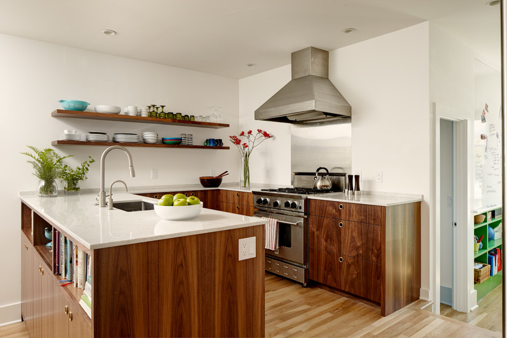 Small minimalist u-shaped light wood floor and beige floor eat-in kitchen photo in Seattle with an undermount sink, flat-panel cabinets, brown cabinets, quartz countertops, white backsplash, stone slab backsplash and stainless steel appliances