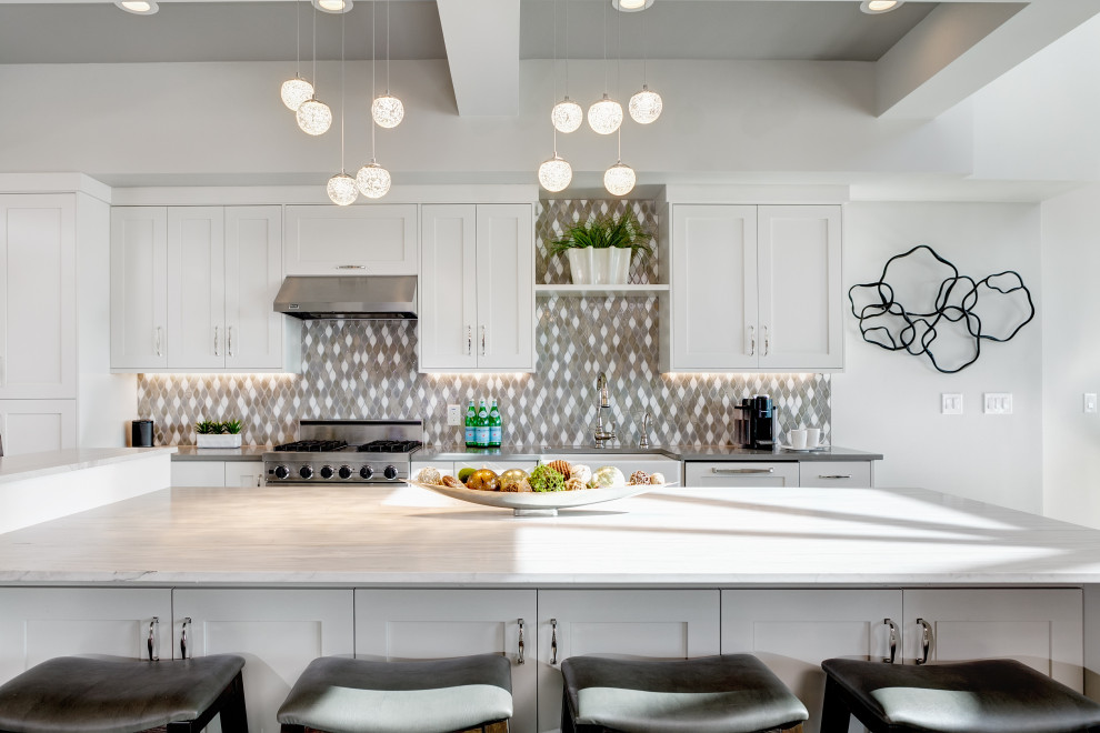 Large transitional l-shaped dark wood floor, gray floor and coffered ceiling eat-in kitchen photo in Boise with a farmhouse sink, shaker cabinets, white cabinets, quartzite countertops, gray backsplash, cement tile backsplash, stainless steel appliances, an island and beige countertops