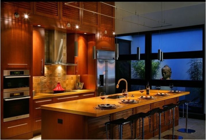 Design ideas for a large classic single-wall kitchen/diner in Miami with a submerged sink, louvered cabinets, medium wood cabinets, stone tiled splashback, stainless steel appliances and an island.