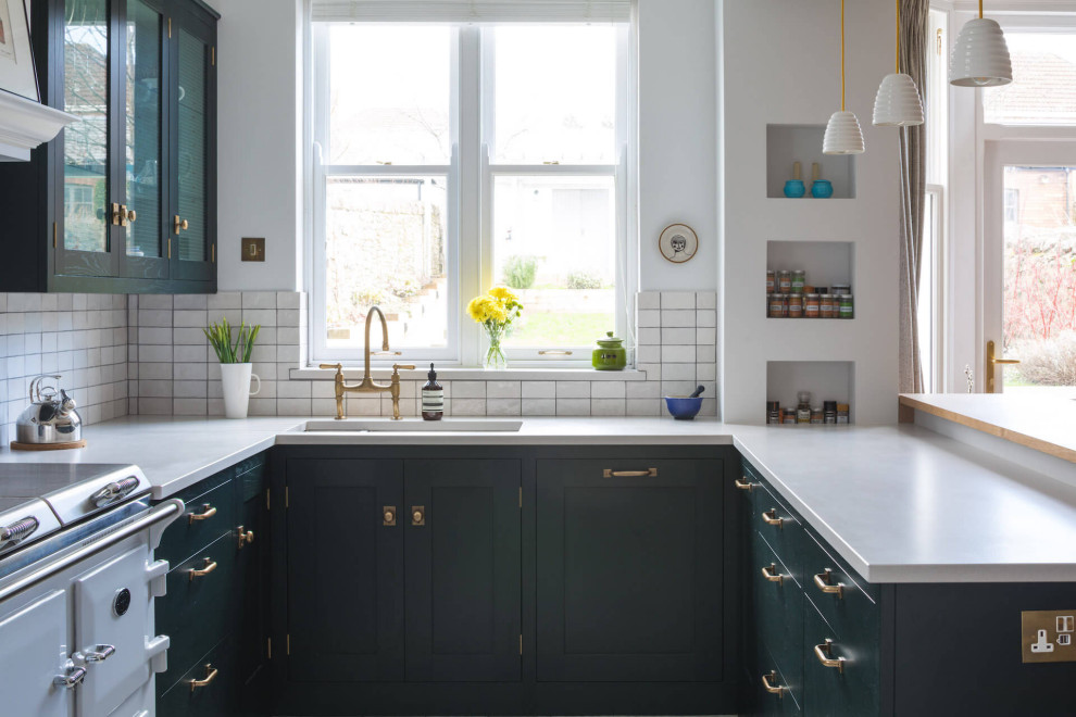 Design ideas for a medium sized classic u-shaped kitchen/diner in Cardiff with a built-in sink, shaker cabinets, green cabinets, composite countertops, white splashback, ceramic splashback, white appliances, ceramic flooring, no island, grey floors and white worktops.