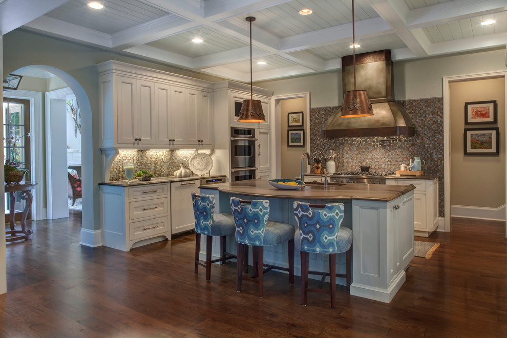 Large island style l-shaped medium tone wood floor and brown floor kitchen photo in Jacksonville with an undermount sink, recessed-panel cabinets, white cabinets, quartzite countertops, multicolored backsplash, mosaic tile backsplash, paneled appliances and an island