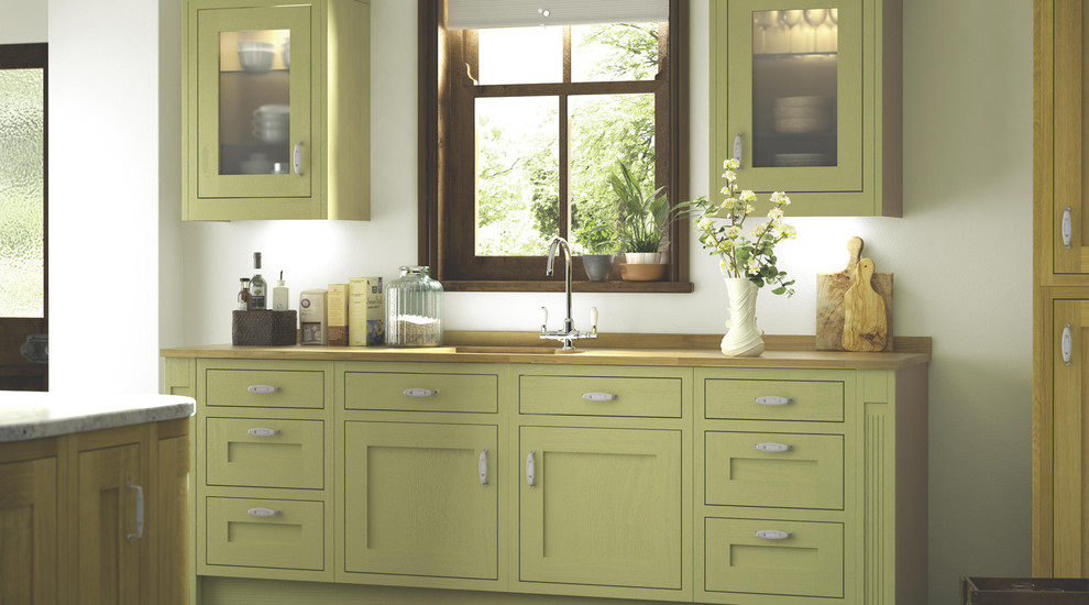 ハンプシャーにあるラグジュアリーなコンテンポラリースタイルのおしゃれなキッチン (フラットパネル扉のキャビネット、緑のキャビネット、木材カウンター) の写真