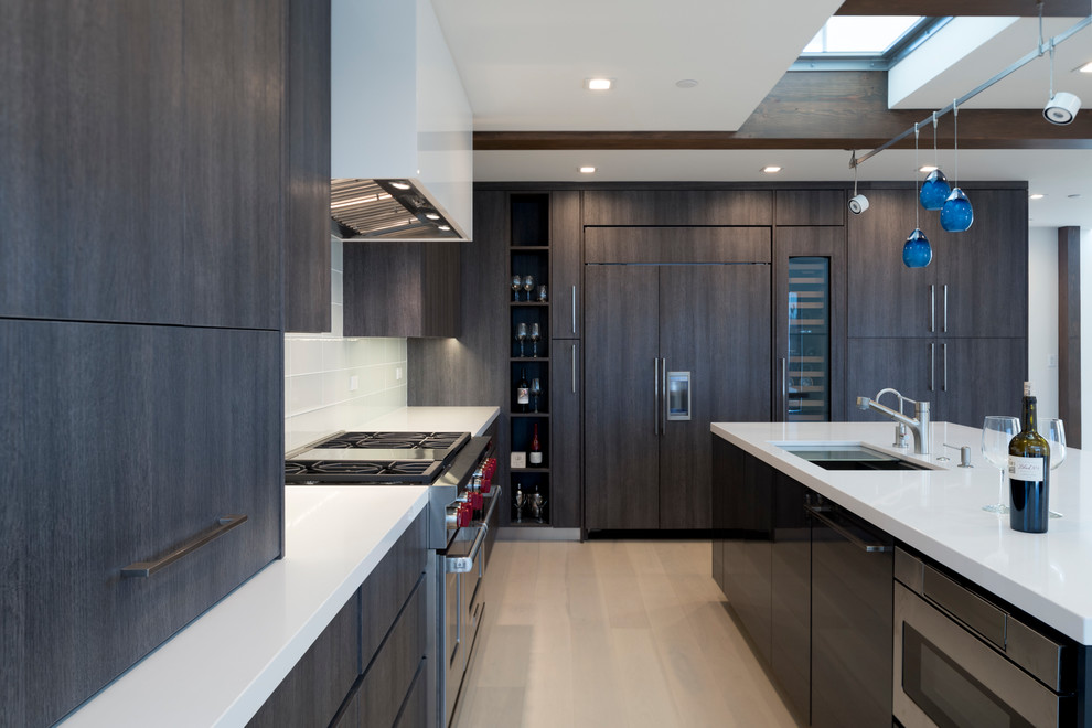 Design ideas for a large modern l-shaped open plan kitchen in San Diego with flat-panel cabinets, dark wood cabinets, engineered stone countertops, an island and white worktops.
