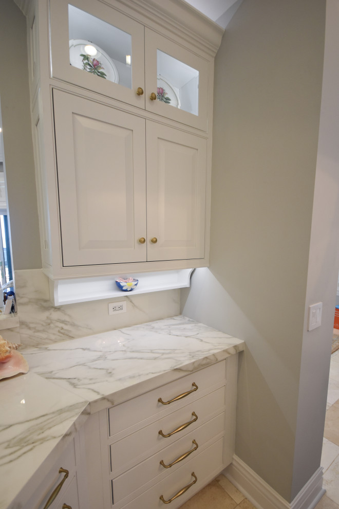 Inspiration for a mid-sized timeless marble floor and beige floor kitchen remodel in Jacksonville with an undermount sink, beaded inset cabinets, white cabinets, quartz countertops, white backsplash, stone slab backsplash, paneled appliances, an island and white countertops