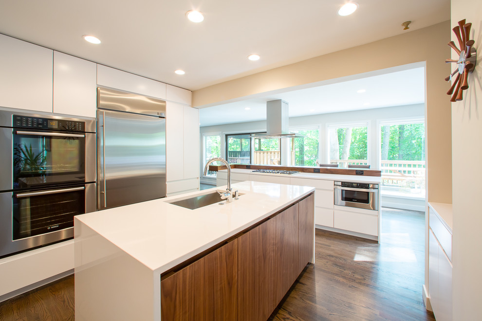 Eat-in kitchen - mid-sized contemporary u-shaped dark wood floor and brown floor eat-in kitchen idea in DC Metro with an undermount sink, flat-panel cabinets, white cabinets, stainless steel appliances, solid surface countertops, two islands and white countertops