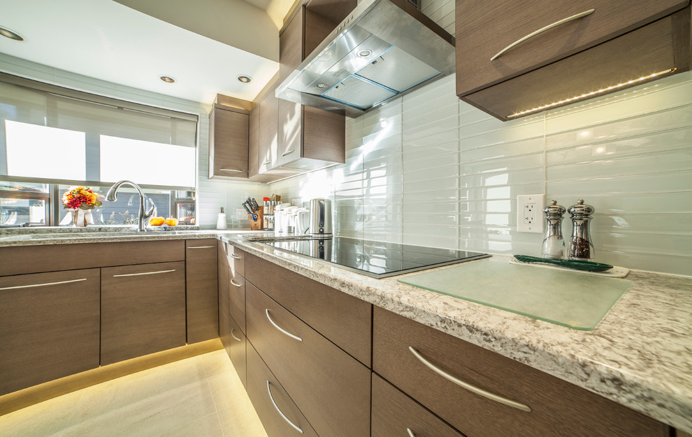 Medium sized contemporary u-shaped enclosed kitchen in Vancouver with a double-bowl sink, flat-panel cabinets, brown cabinets, engineered stone countertops, white splashback, glass tiled splashback, stainless steel appliances, porcelain flooring and an island.