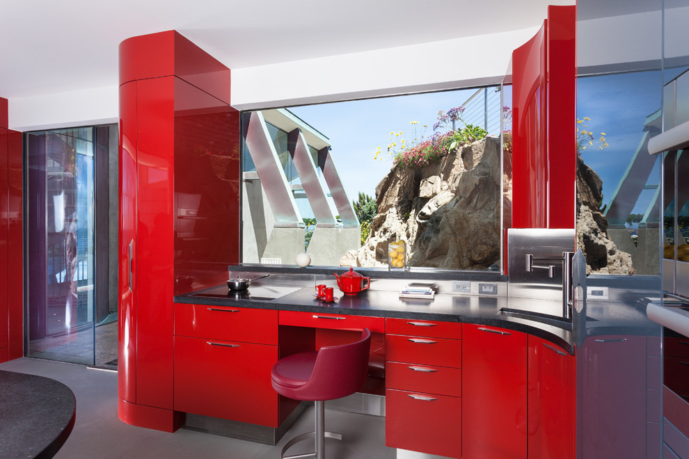 Large minimalist u-shaped concrete floor eat-in kitchen photo in San Francisco with a double-bowl sink, flat-panel cabinets, red cabinets, metallic backsplash, stainless steel appliances and an island