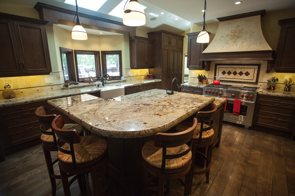 Example of a large classic u-shaped dark wood floor enclosed kitchen design in San Francisco with a single-bowl sink, shaker cabinets, dark wood cabinets, granite countertops, beige backsplash, ceramic backsplash, stainless steel appliances and an island