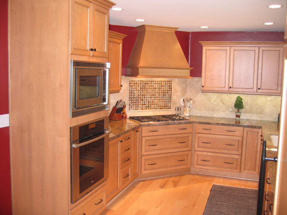 Example of a small classic u-shaped light wood floor and beige floor kitchen design in Sacramento with an undermount sink, raised-panel cabinets, light wood cabinets, granite countertops, beige backsplash, ceramic backsplash, stainless steel appliances, no island and brown countertops