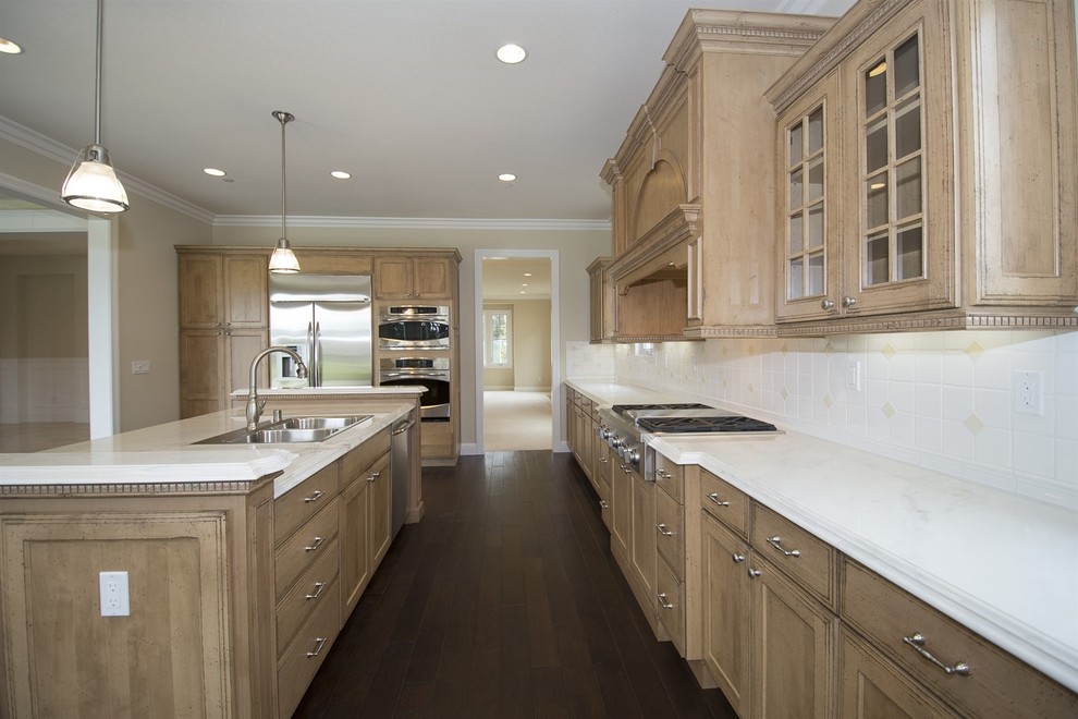 Inspiration for a large traditional l-shaped open plan kitchen in San Francisco with a built-in sink, recessed-panel cabinets, distressed cabinets, marble worktops, multi-coloured splashback, porcelain splashback, stainless steel appliances, medium hardwood flooring, an island and multi-coloured floors.