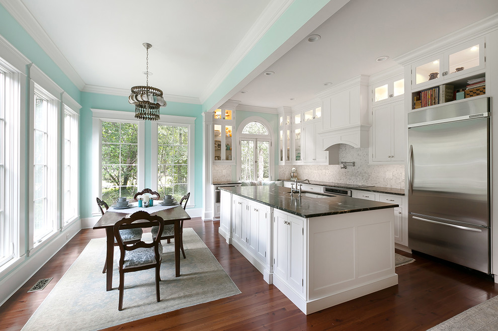 Eat-in kitchen - mid-sized traditional l-shaped eat-in kitchen idea in Charleston with shaker cabinets, white cabinets, multicolored backsplash, mosaic tile backsplash, stainless steel appliances and an island