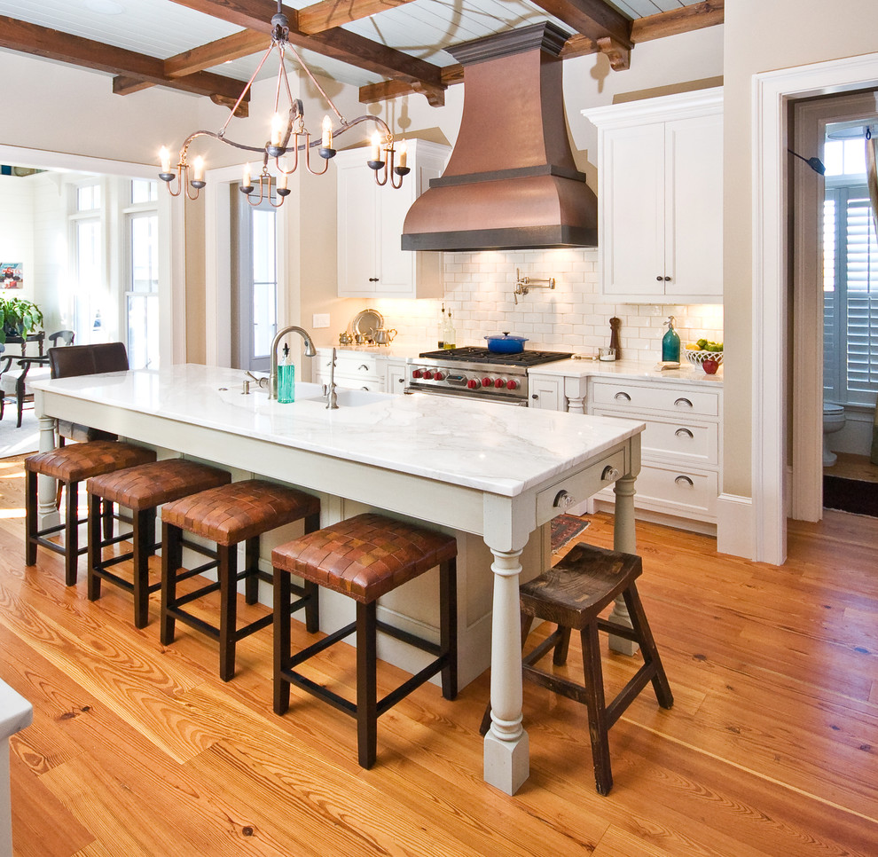 Elegant kitchen photo in Charleston with white cabinets, marble countertops, white backsplash, subway tile backsplash and stainless steel appliances