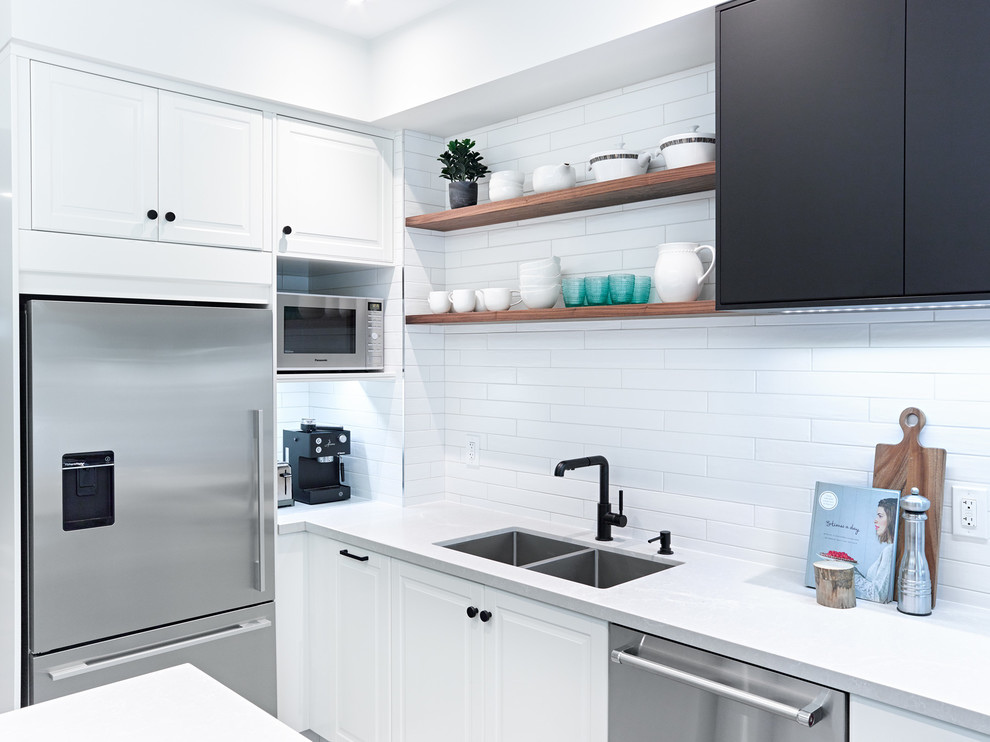 Photo of a medium sized traditional galley enclosed kitchen in Toronto with a submerged sink, recessed-panel cabinets, white cabinets, engineered stone countertops, white splashback, metro tiled splashback, stainless steel appliances, porcelain flooring, an island and grey floors.