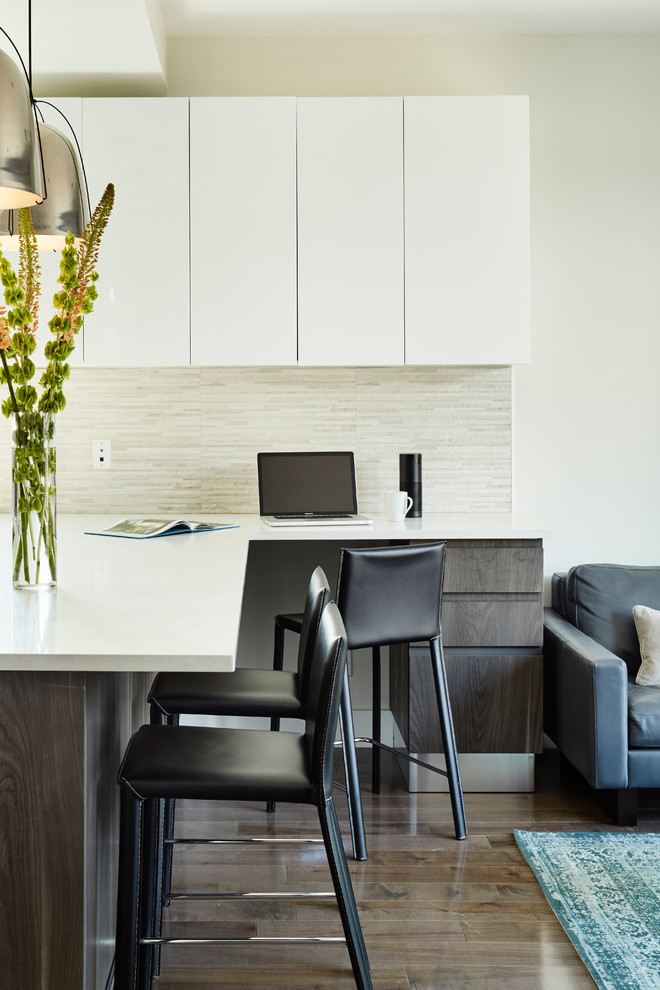 Offene Moderne Küche mit flächenbündigen Schrankfronten, weißen Schränken, Küchenrückwand in Beige, braunem Holzboden und Halbinsel in New York