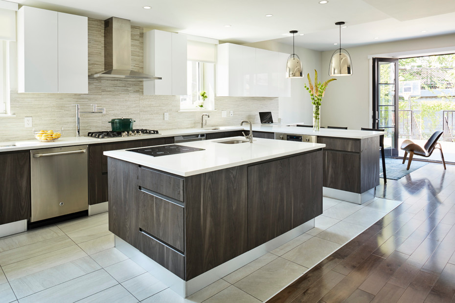 Photo of a large contemporary u-shaped open plan kitchen in New York with a submerged sink, flat-panel cabinets, grey cabinets, engineered stone countertops, grey splashback, porcelain splashback, stainless steel appliances, porcelain flooring and an island.