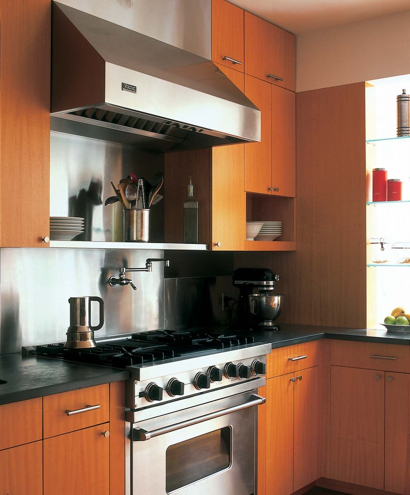 Réalisation d'une cuisine minimaliste en bois brun avec un placard à porte plane et un électroménager en acier inoxydable.