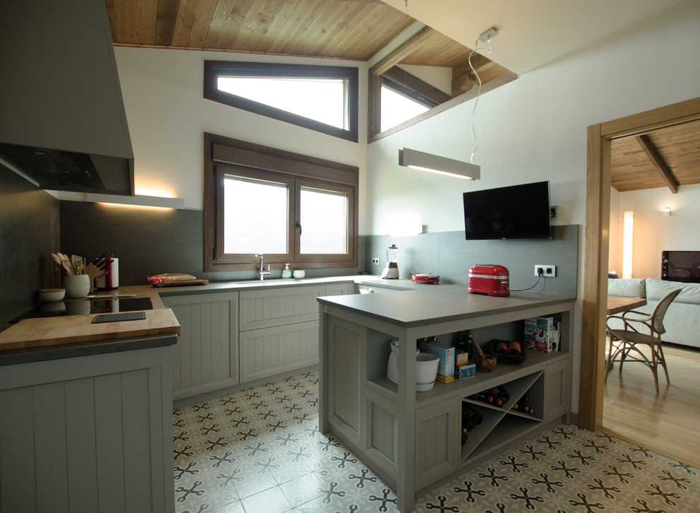 Photo of a medium sized country u-shaped enclosed kitchen in Other with an integrated sink, beaded cabinets, grey cabinets, wood worktops, stainless steel appliances, ceramic flooring and a breakfast bar.