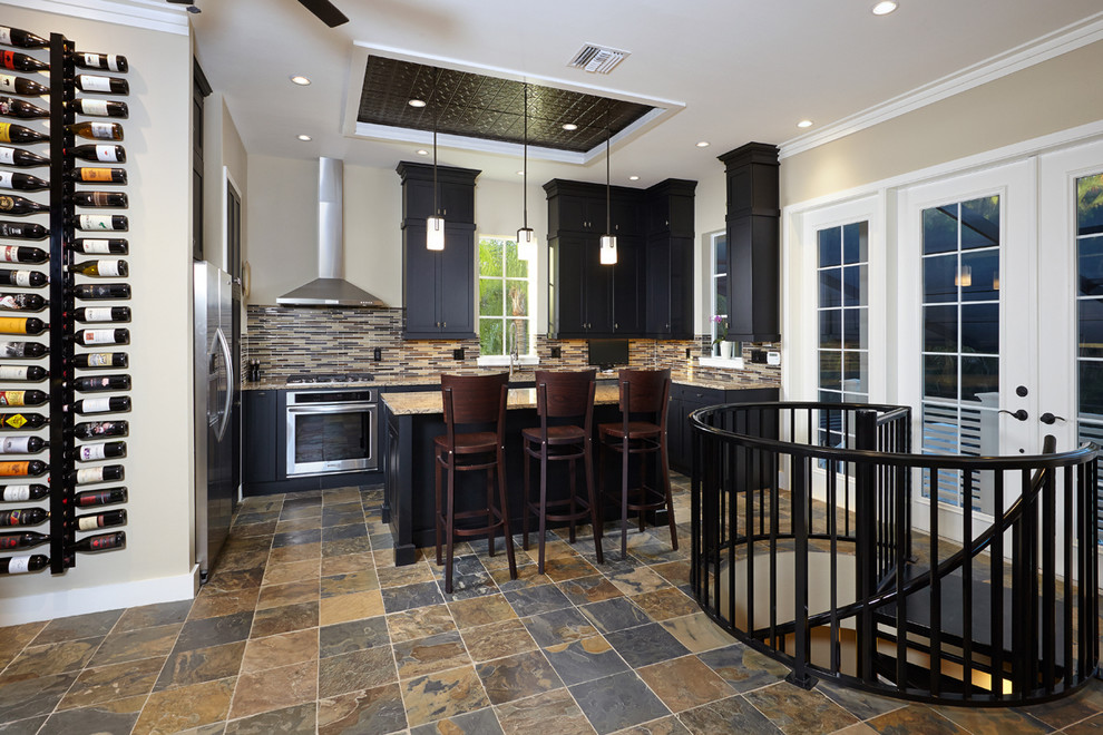 Example of a mid-sized island style slate floor kitchen design in Miami with an undermount sink, shaker cabinets, black cabinets, quartz countertops, glass sheet backsplash, stainless steel appliances and an island