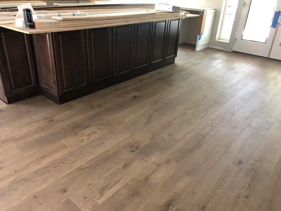 Example of a large classic l-shaped medium tone wood floor and brown floor eat-in kitchen design in San Diego with an island and brown countertops