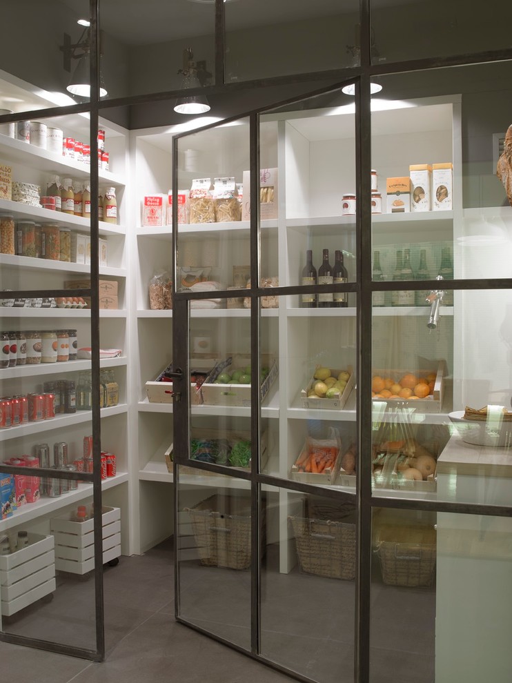 This is an example of a medium sized modern kitchen pantry in Barcelona.