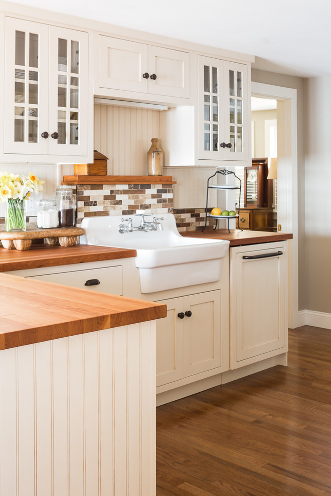 Maritime Küche mit Landhausspüle, Schrankfronten im Shaker-Stil, weißen Schränken, Arbeitsplatte aus Holz, Küchenrückwand in Braun, braunem Holzboden und Halbinsel in Portland Maine