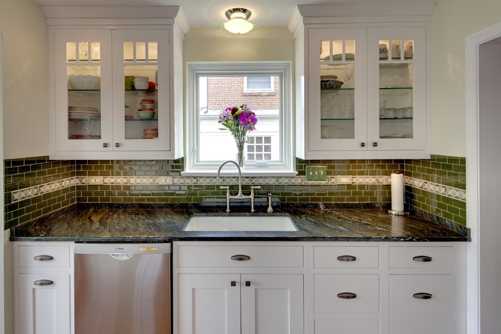 Inspiration for a timeless kitchen remodel in DC Metro with glass-front cabinets, white cabinets, granite countertops, green backsplash, subway tile backsplash and stainless steel appliances