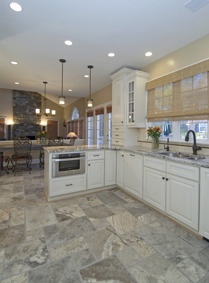 Trendy kitchen photo in DC Metro with an undermount sink, raised-panel cabinets, white cabinets and beige backsplash