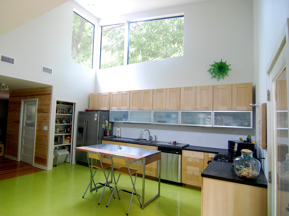 オースティンにあるコンテンポラリースタイルのおしゃれなキッチン (ガラス扉のキャビネット、緑の床) の写真