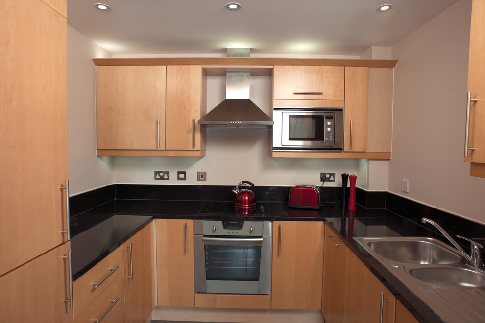 Photo of a medium sized contemporary u-shaped enclosed kitchen in Other.