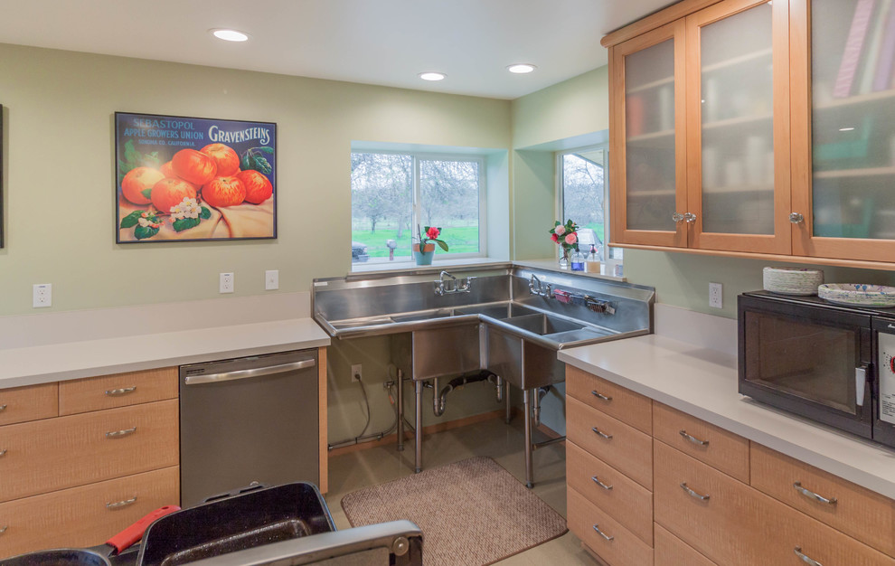 Example of a mid-sized urban galley vinyl floor kitchen pantry design in Other with a triple-bowl sink, recessed-panel cabinets, medium tone wood cabinets, stainless steel countertops, white backsplash, stainless steel appliances and no island