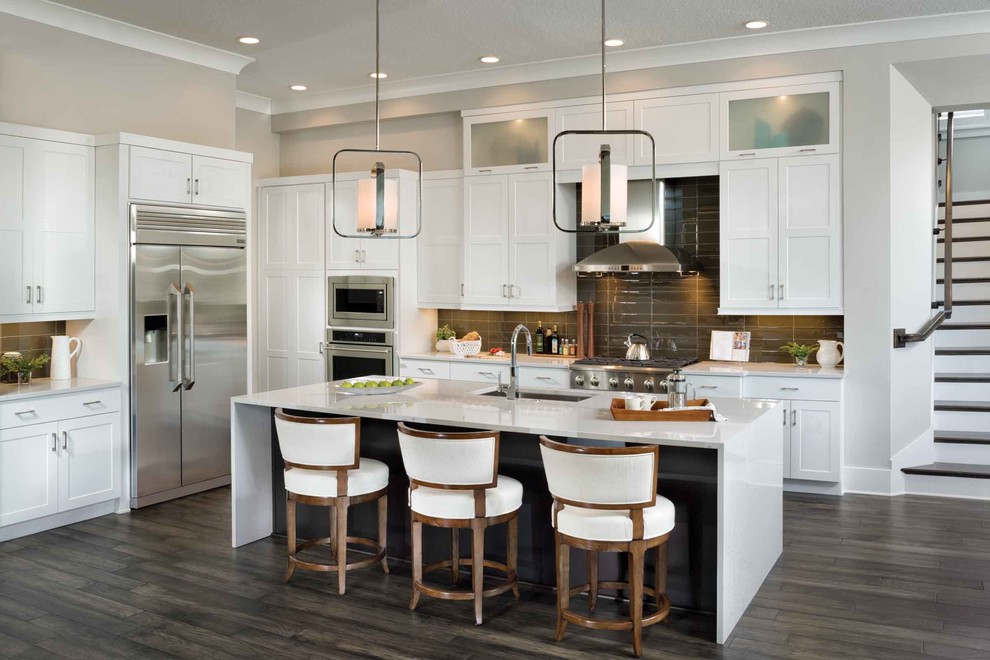 Transitional dark wood floor and brown floor kitchen photo in Miami with an undermount sink, shaker cabinets, white cabinets, brown backsplash, stainless steel appliances and an island