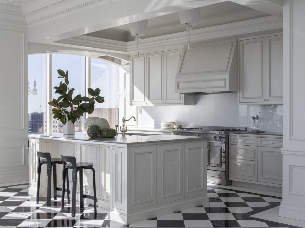 Enclosed kitchen - large traditional galley multicolored floor and porcelain tile enclosed kitchen idea in San Francisco with white cabinets, white backsplash, an island, an undermount sink, beaded inset cabinets and marble countertops
